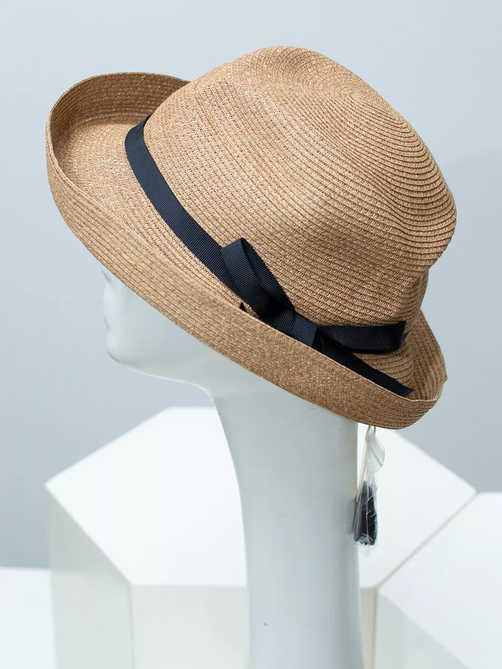 Beige straw sun hat with black ribbon bow detail