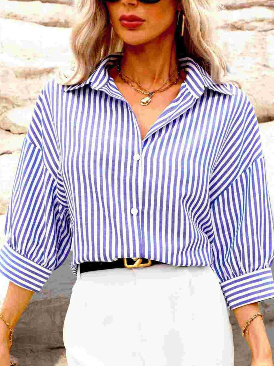 white button-down shirt featuring buttoned and striped