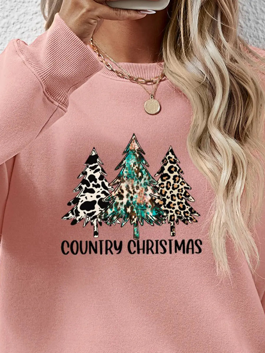 Blush pink crewneck sweatshirt with country Christmas trees graphic and text.