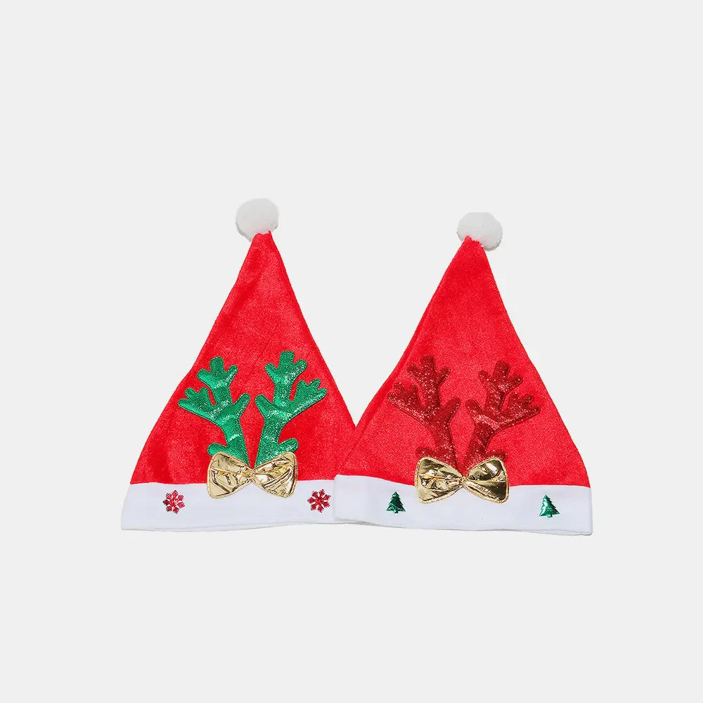 Red velvet party hats with reindeer antlers and gold bows, perfect for festive celebrations.