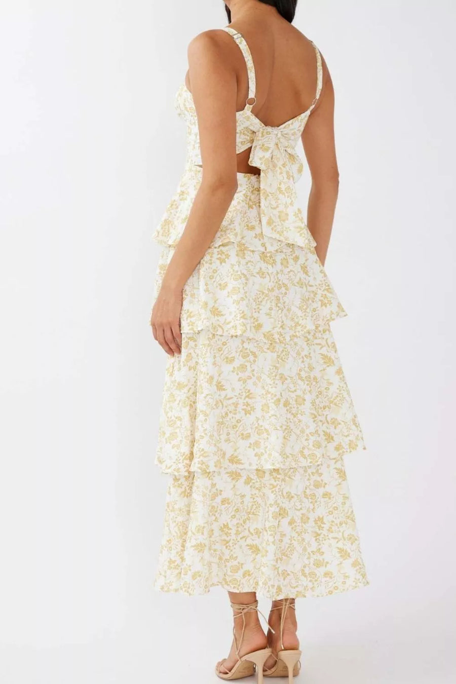White tiered maxi skirt with yellow floral print and tie-back crop top.