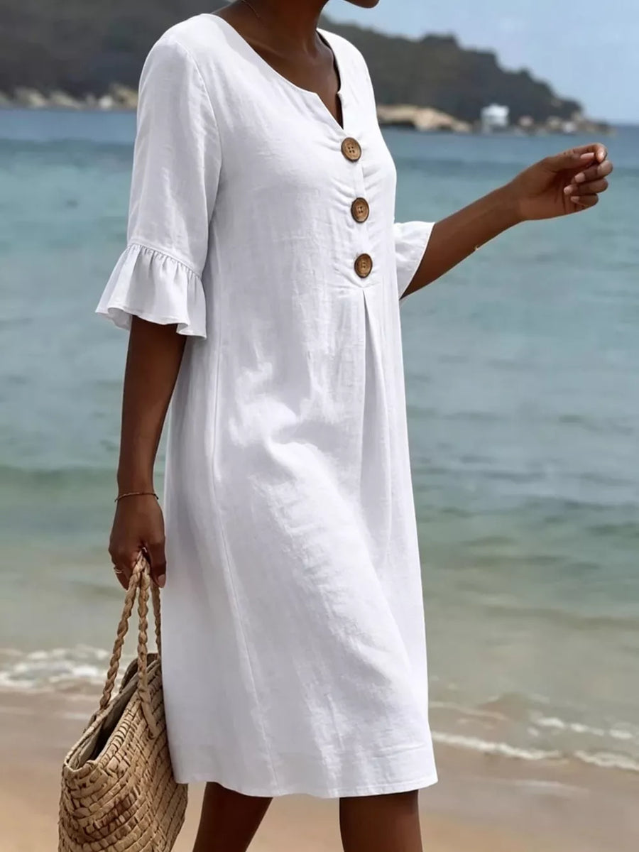 White ruffled sleeve button detail dress with V-neck and wooden buttons.
