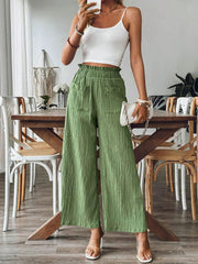 Green textured gauze palazzo trousers with elastic waist and pockets.
