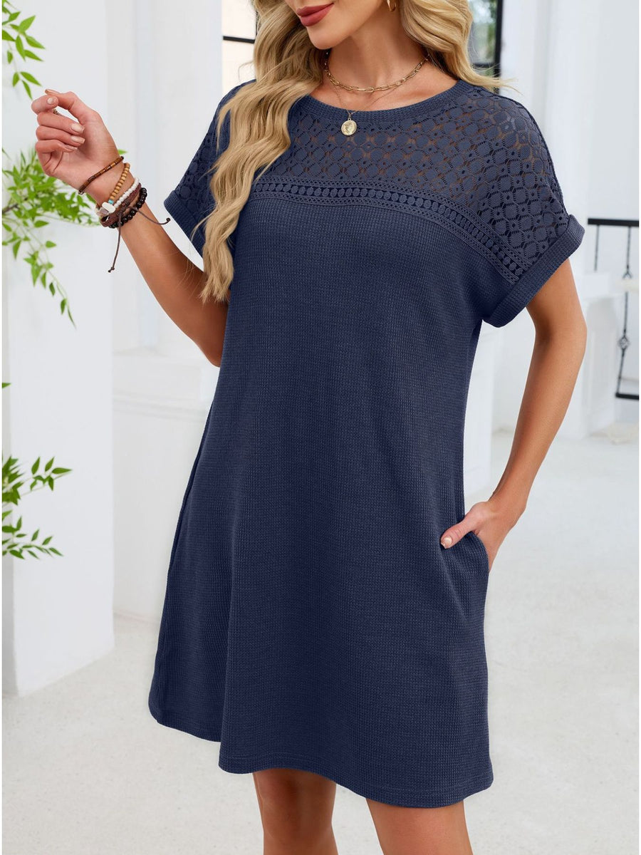 Navy blue t-shirt dress with short sleeves and a sheer lace yoke detail.