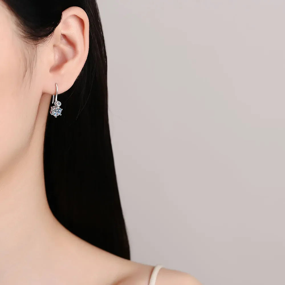 Silver drop earrings with a sparkling solitaire gem and a small round bead detail.