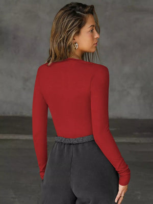 Burgundy long-sleeve top with deep V-neck and cutout detail.