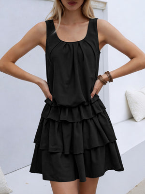 Black ruffled tiered mini dress with a gathered neckline and elastane.