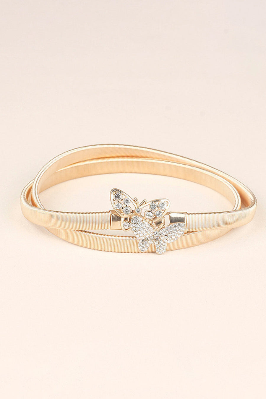 Gold elastic belt with a double band and a crystal butterfly clasp.