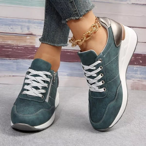Dark green lace-up wedge sneakers with side zipper and white laces.