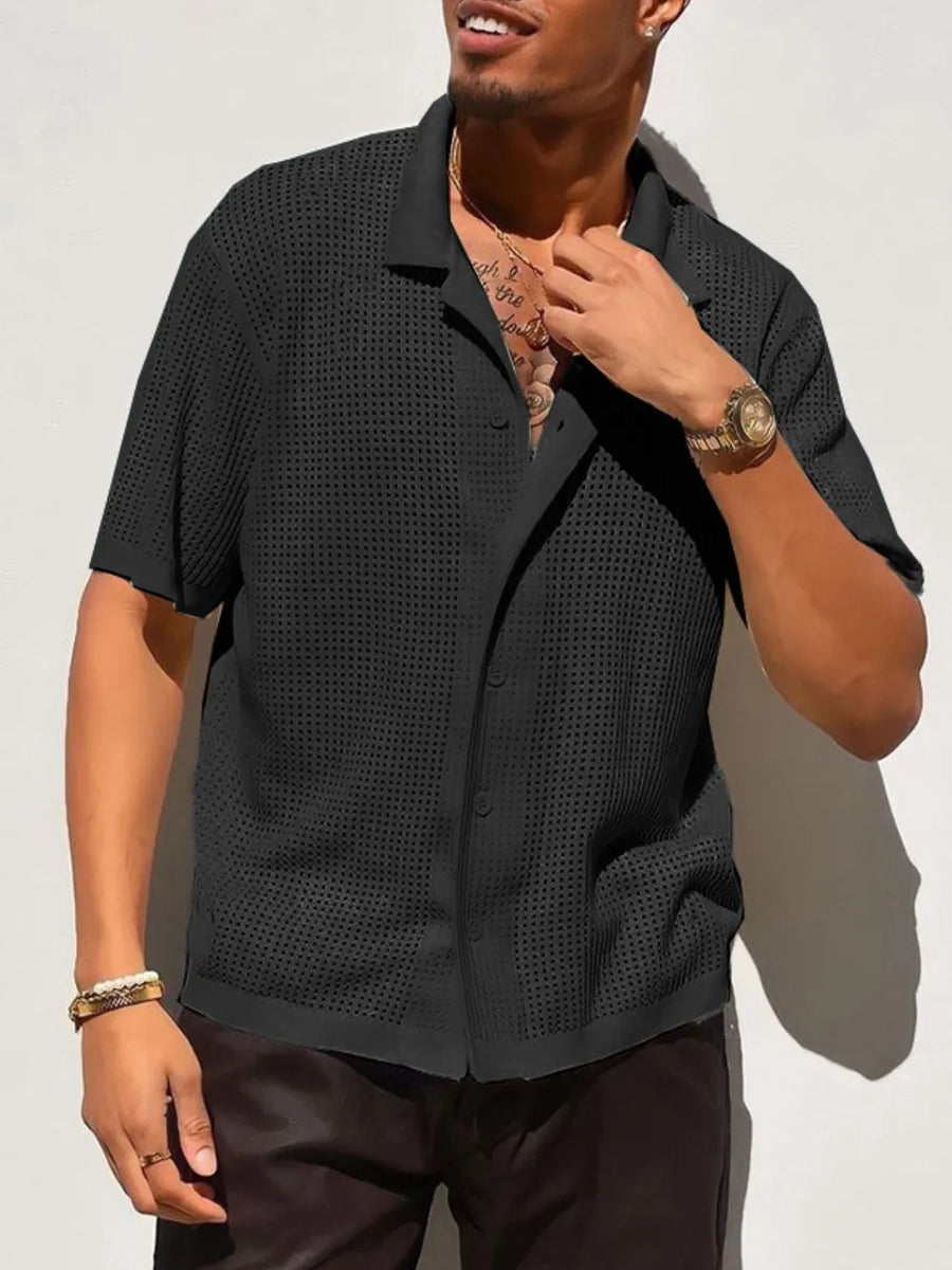 Black perforated knit resort shirt with short sleeves and a spread collar.