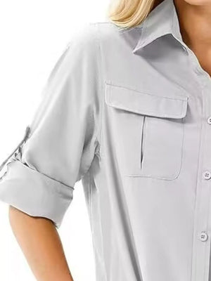 Light gray button-up shirt with roll-up sleeves and chest pockets.