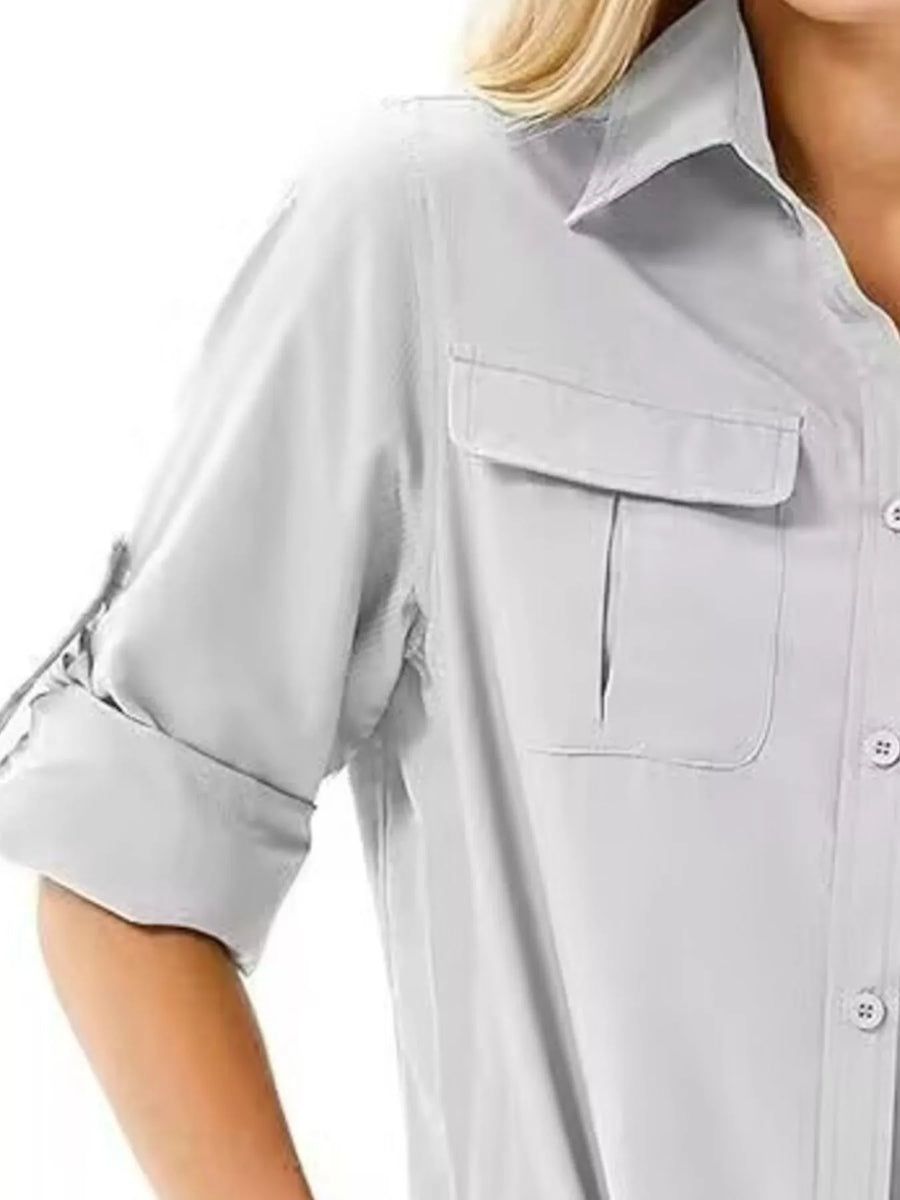 Light gray button-up shirt with roll-up sleeves and chest pockets.