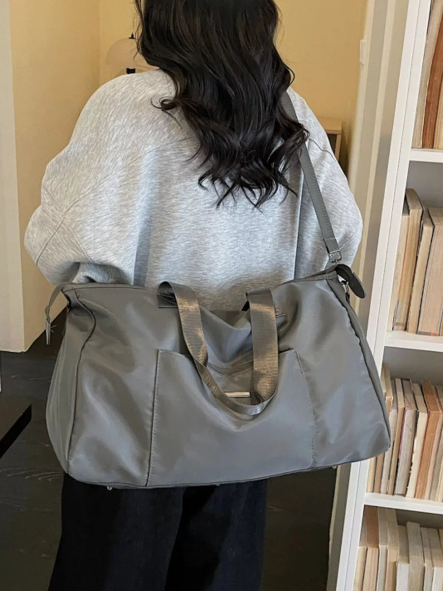 Minimalist large grey Oxford cloth travel bag with front pocket and shoulder strap
