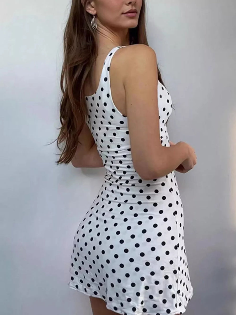 White polka dot mini dress with scoop neck and sleeveless cut.