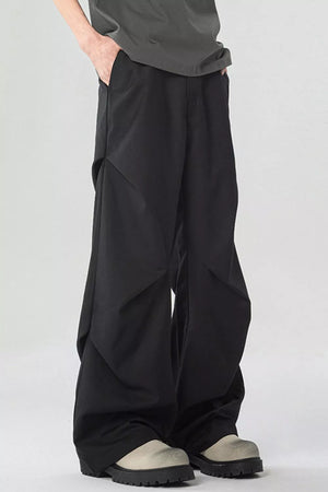 Black wide-leg sweatpants with pockets and unique paneling detail.