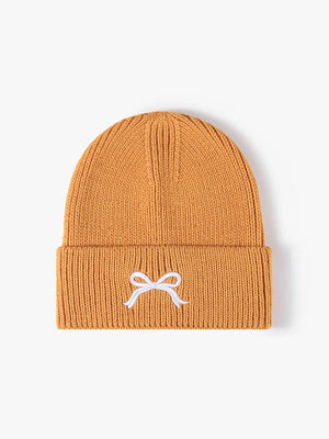 Tangerine ribbed knit beanie with embroidered white bow detail