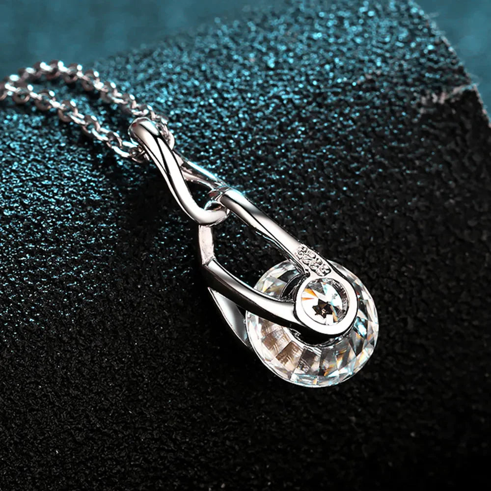 Silver necklace with a clear crystal solitaire pendant and delicate chain.