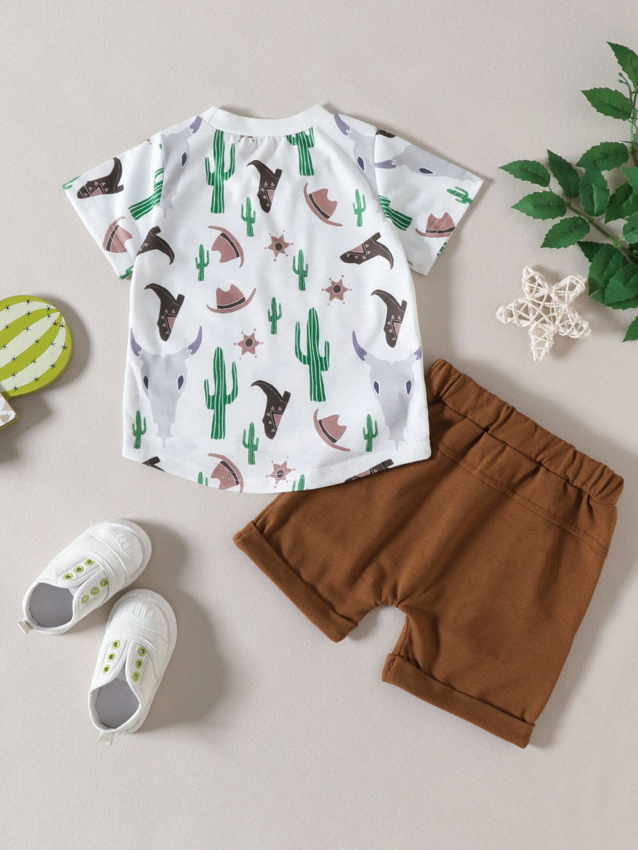 Baby set with cactus, cowboy hat, and bull skull print on white tee and brown shorts.