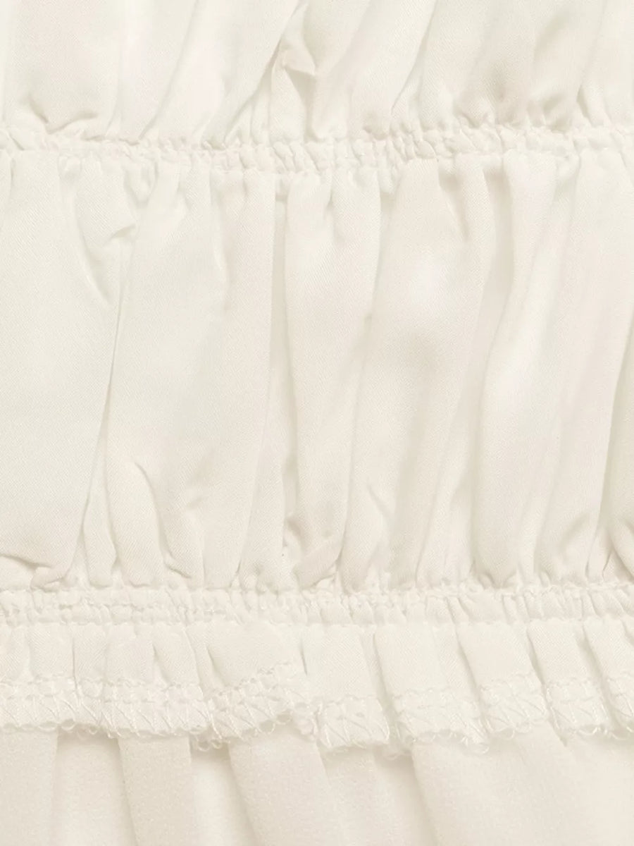 Gathered neckline peplum cami top in white with ruffled hem detail