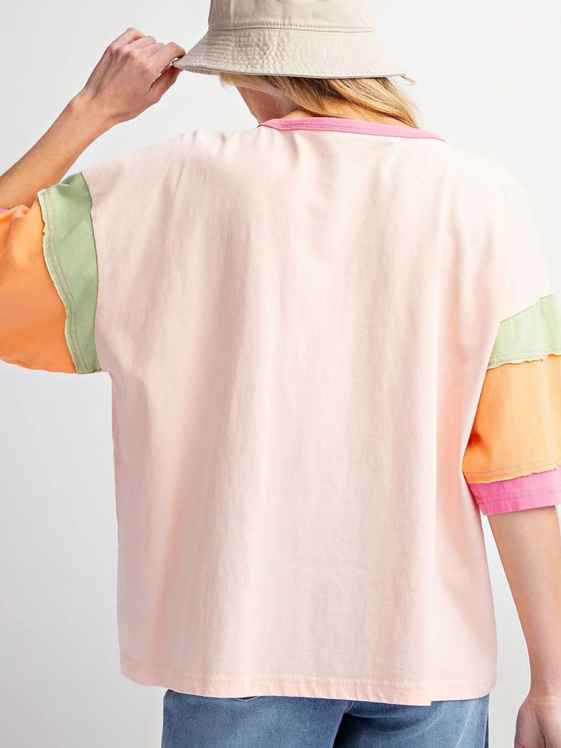 Cotton colorblock t-shirt in watermelon pink with green and orange sleeves and pink trim.