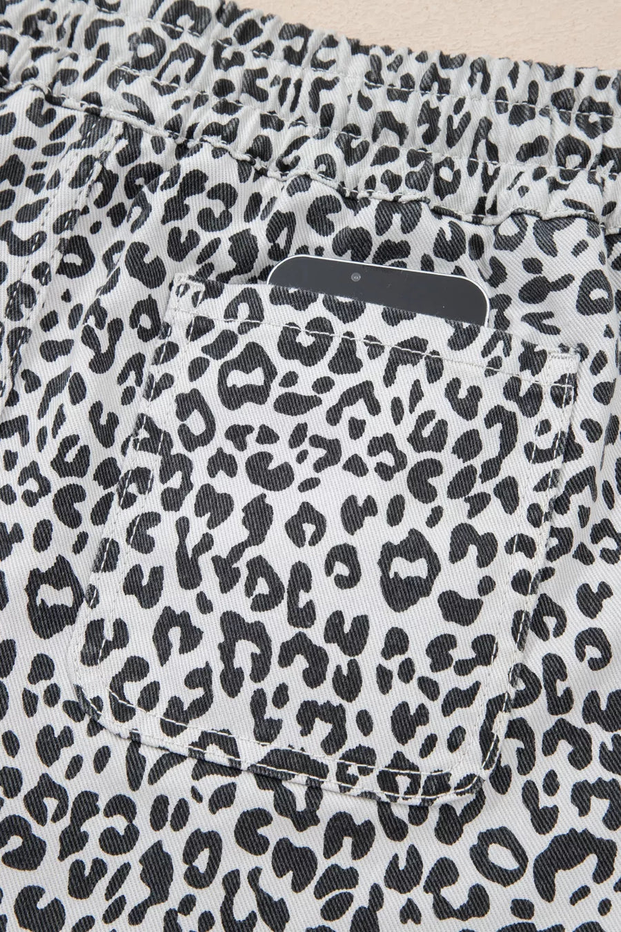 Leopard print denim skort with pockets and elastic waistband.