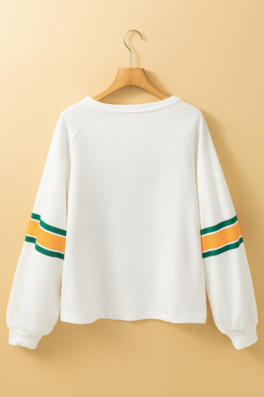 White raglan sleeve sweatshirt with green and orange stripes on sleeves.