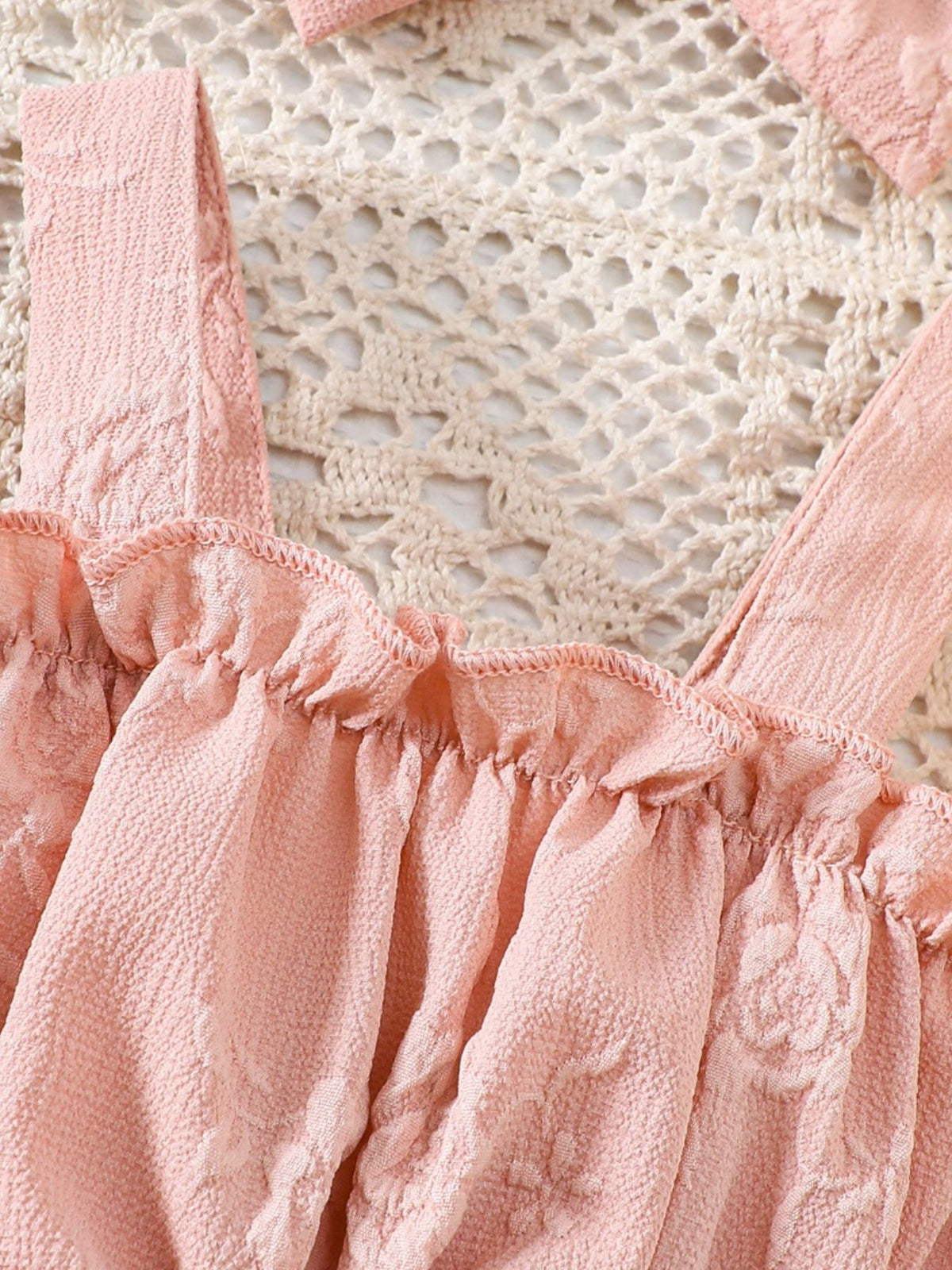 Pink floral embossed baby one-piece with ruffles and headband. Cotton blend.