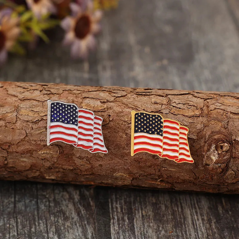 Waving flag enamel pins, one silver-toned and one gold-toned, with butterfly clutches.