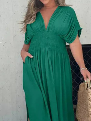 Maternity maxi dress in dark green with V-neck, dolman sleeves, and smocked waist.