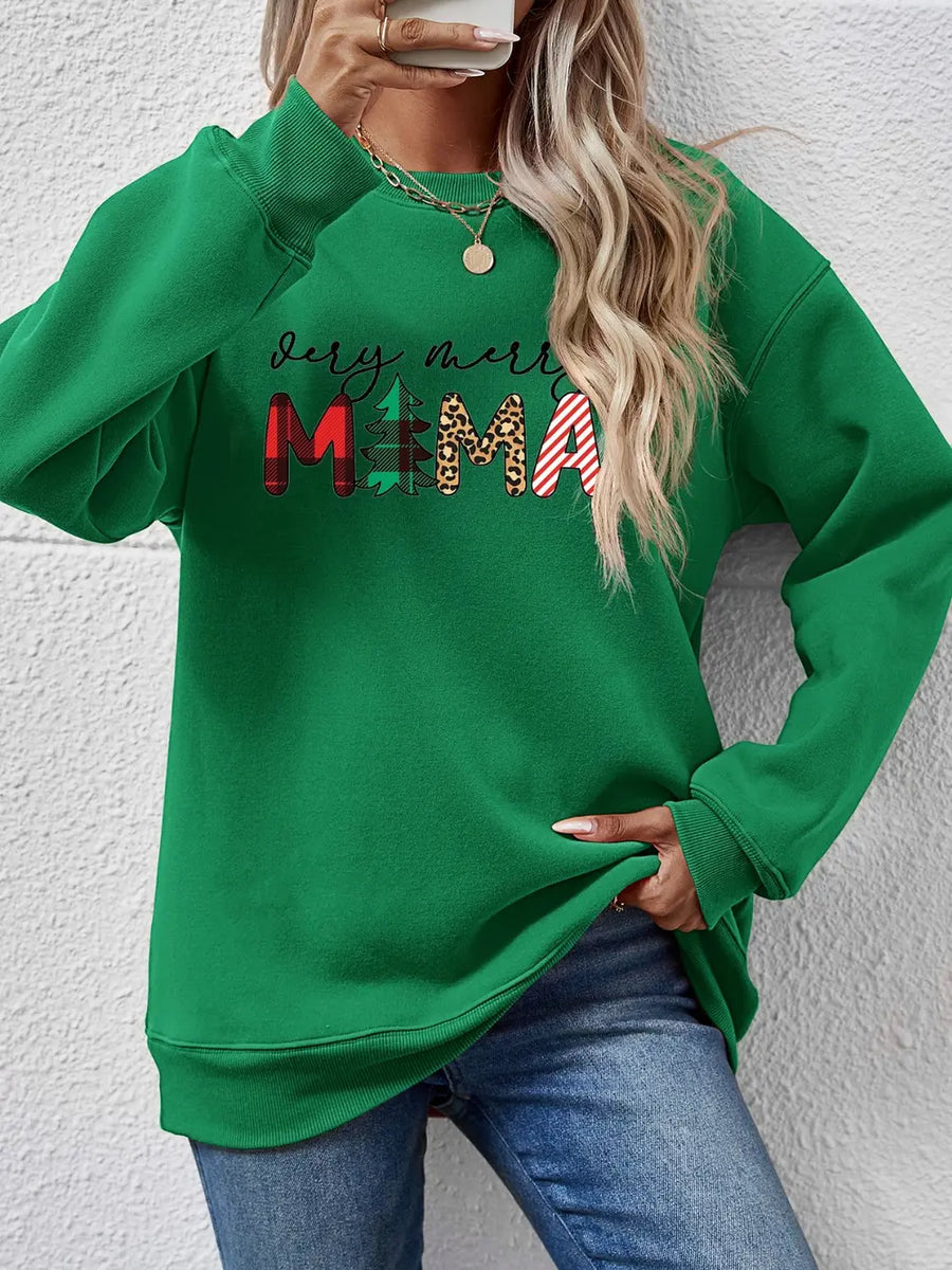 Green long sleeve sweater with abstract Christmas graphic print and crew neck.