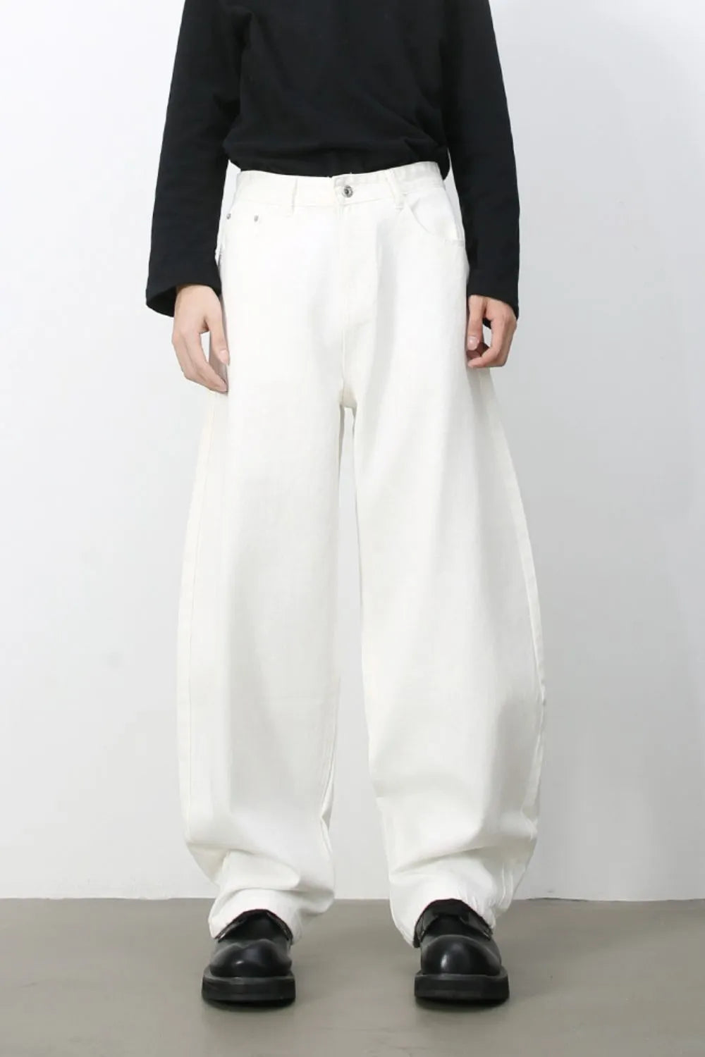 Sculpted white denim balloon trousers with a high waist and wide leg.