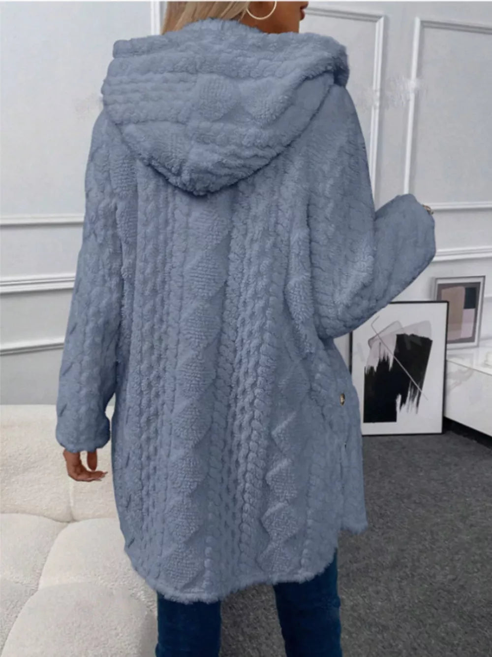 Cozy hooded fleece trench coat in dusty blue with cable knit texture and button detail.