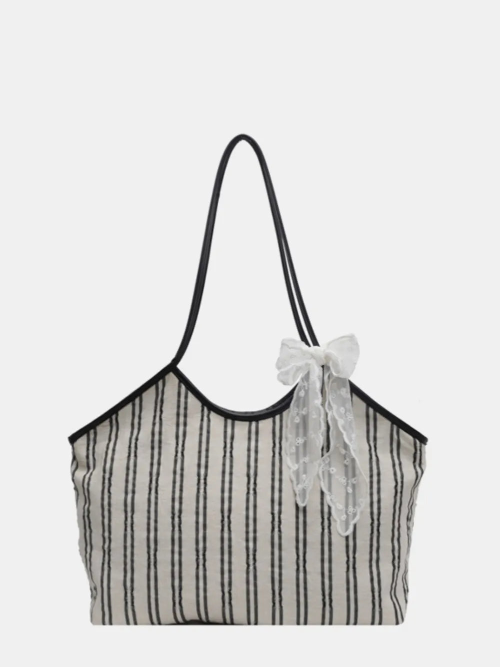 Beige shopper bag with black stripes and a white lace bow detail.