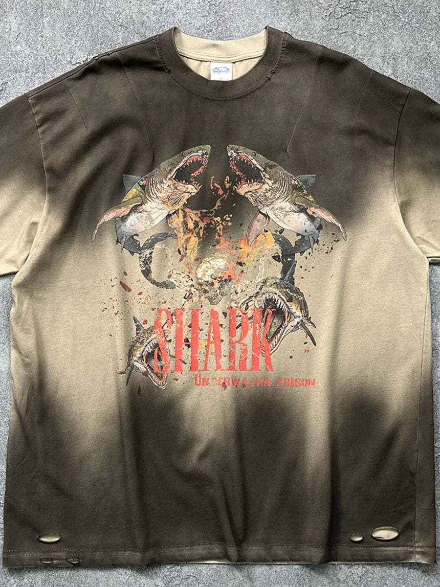 Distressed khaki t-shirt with a bold shark graphic and distressed details.