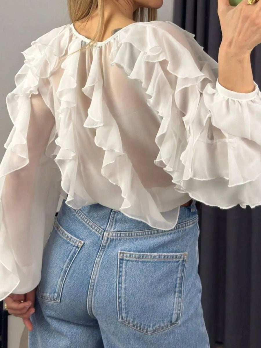White sheer ruffled long-sleeve blouse with voluminous ruffles.