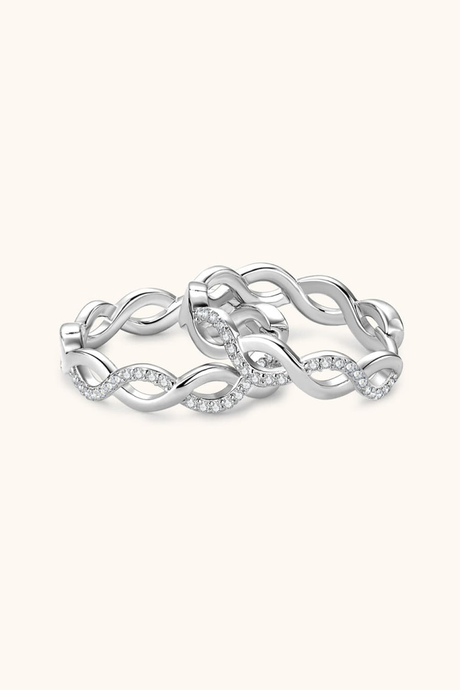 Silver braided pavé hoop earrings with a twisted infinity design.