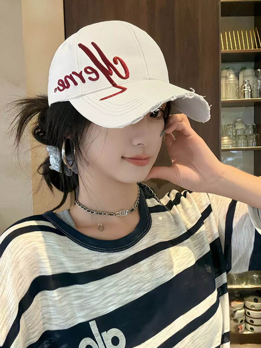 Off-white distressed baseball cap with red embroidery and frayed brim