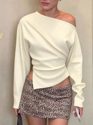 Apricot draped asymmetrical off-shoulder t-shirt with long sleeves.