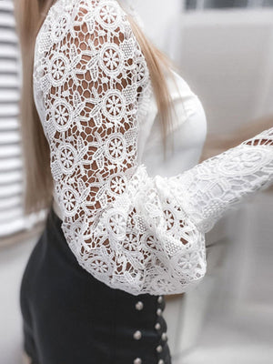 White lace long-sleeve button-down blouse with intricate floral pattern and bell sleeves.