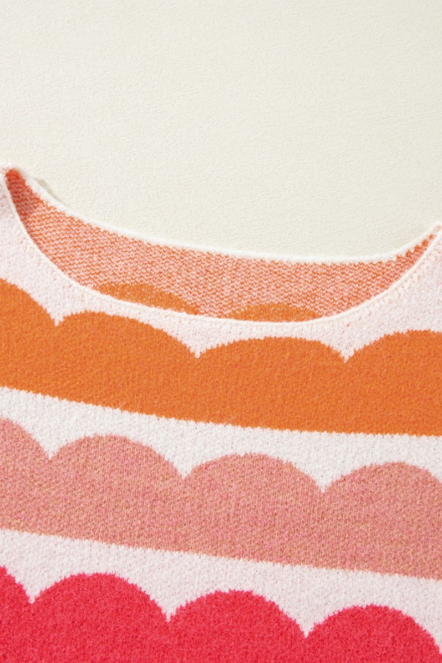 Scalloped stripe off-the-shoulder sweater in acrylic with a boatneck and colorful stripes.