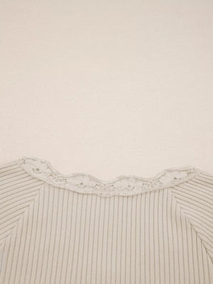 Beige ribbed long-sleeve top with delicate lace trim neckline.