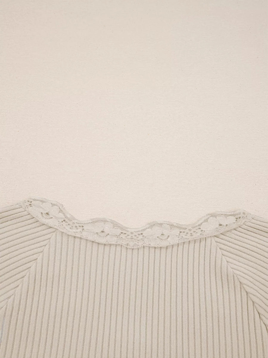 Beige ribbed long-sleeve top with delicate lace trim neckline.