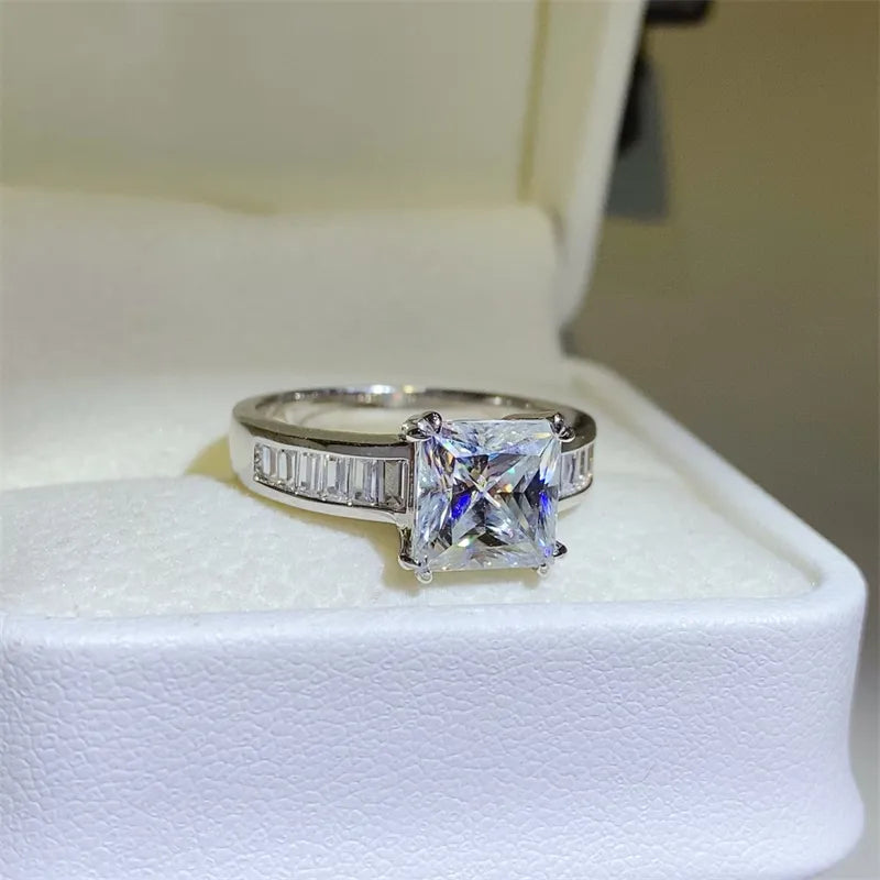 Princess cut diamond ring with baguette band in silver.