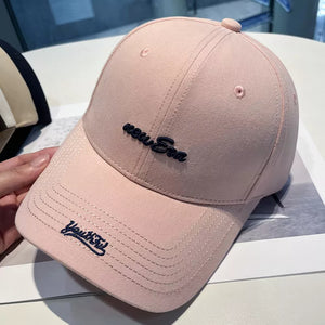 Pink baseball cap with embroidered "new Era" and "Youthful" details