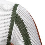 Textured white polo with green stripe detail and open collar.