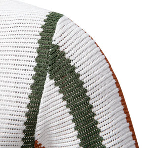 Textured white polo with green stripe detail and open collar.