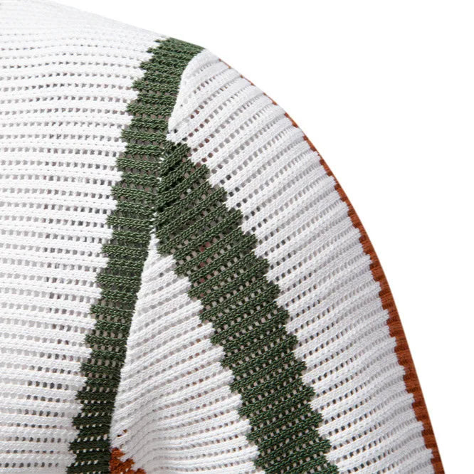 Textured white polo with green stripe detail and open collar.