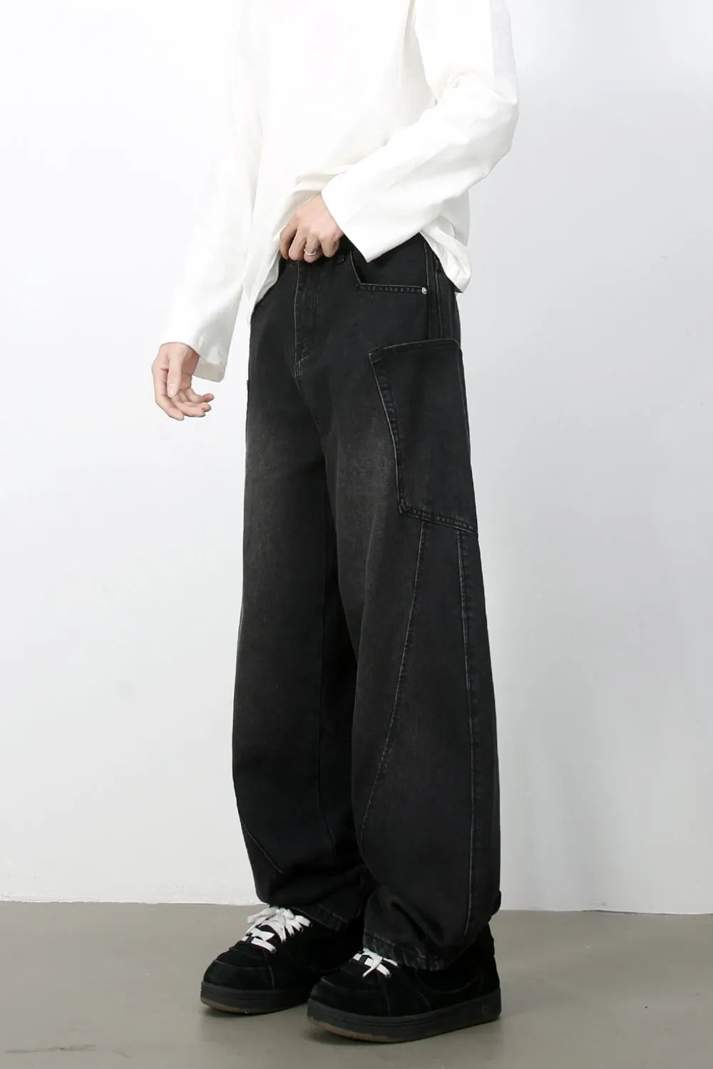 Black denim baggy trousers with a relaxed fit and large front pockets.