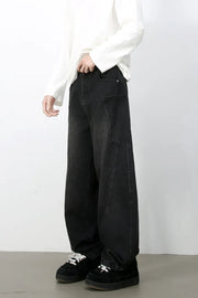 Black denim baggy trousers with a relaxed fit and large front pockets.