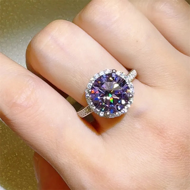 Violet halo sterling silver ring with large purple center stone and small clear accent stones.